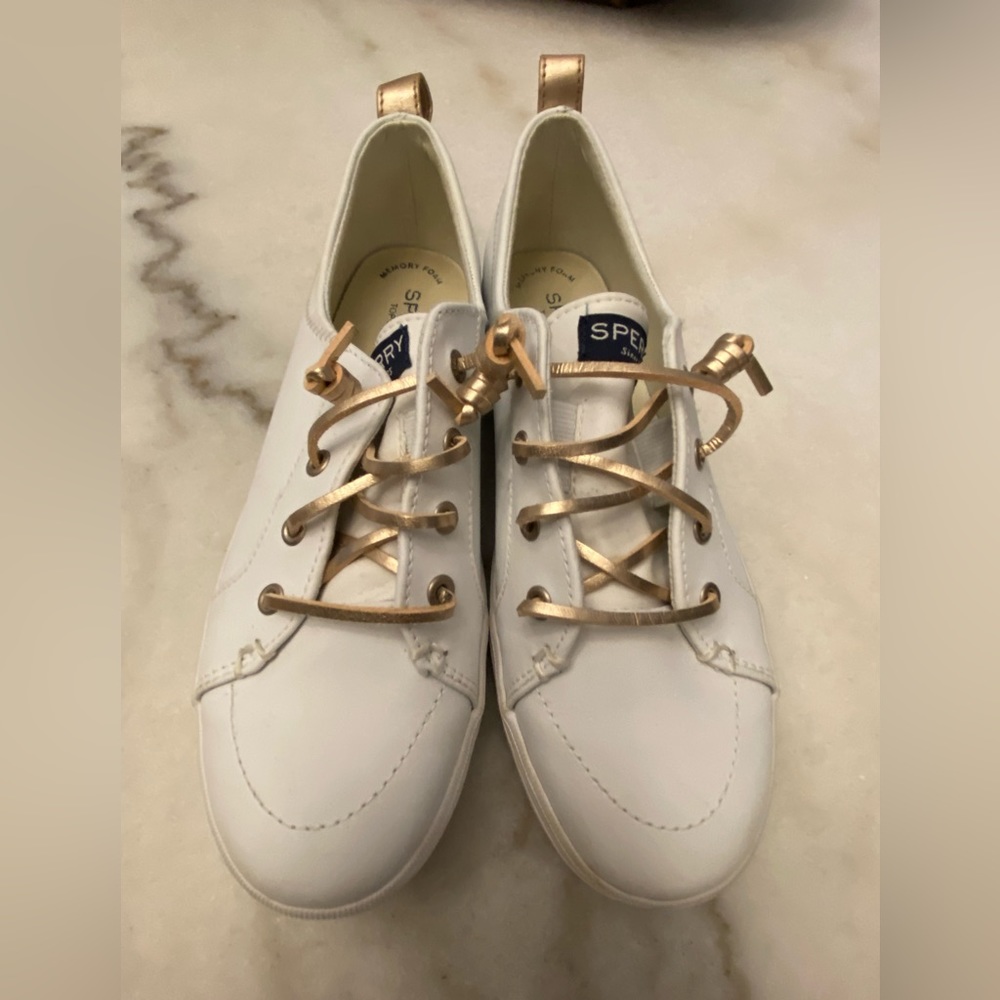 Sperry white sneakers w gold leather laces.